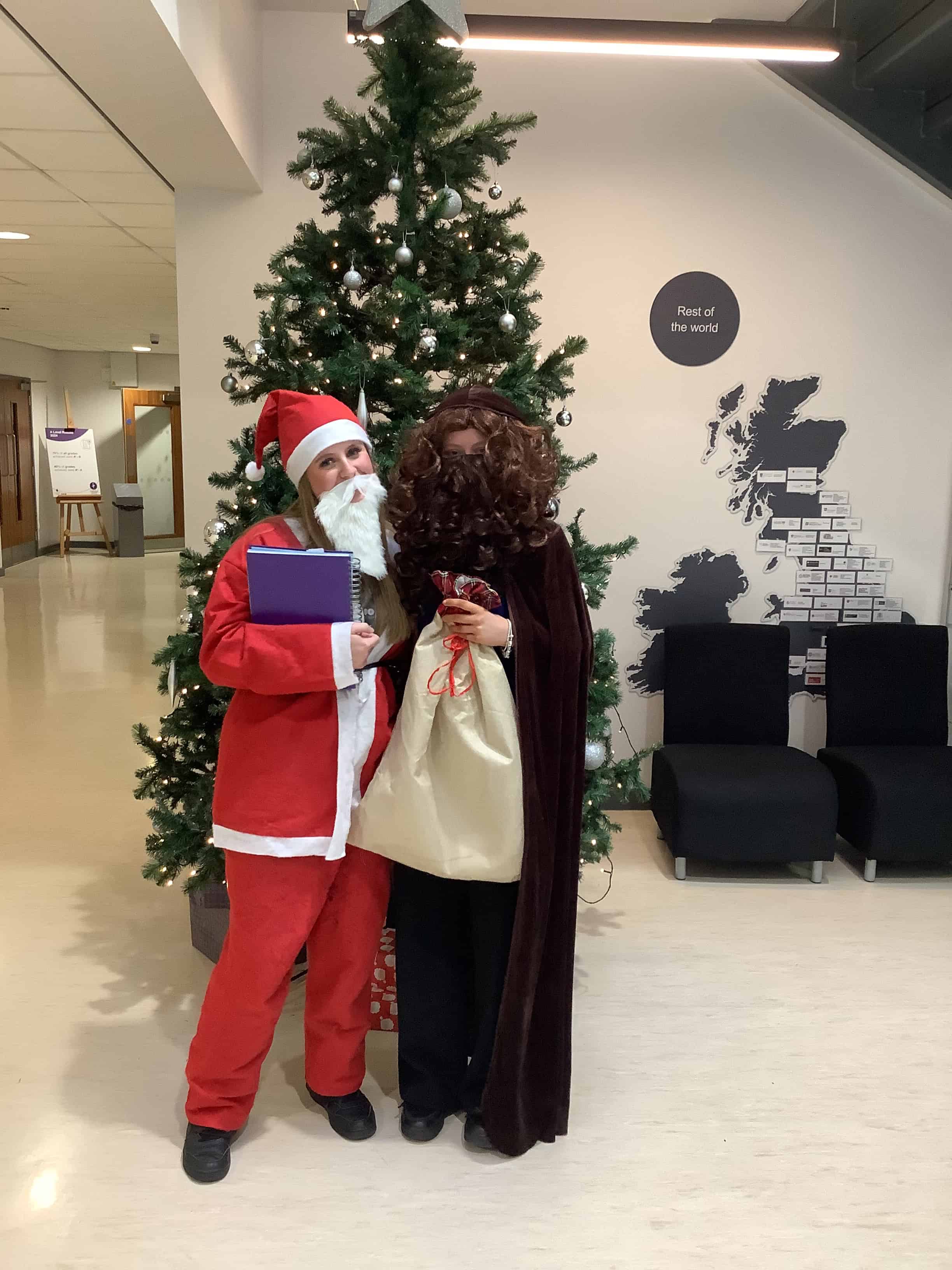 Image of students dressed up as santa with presents