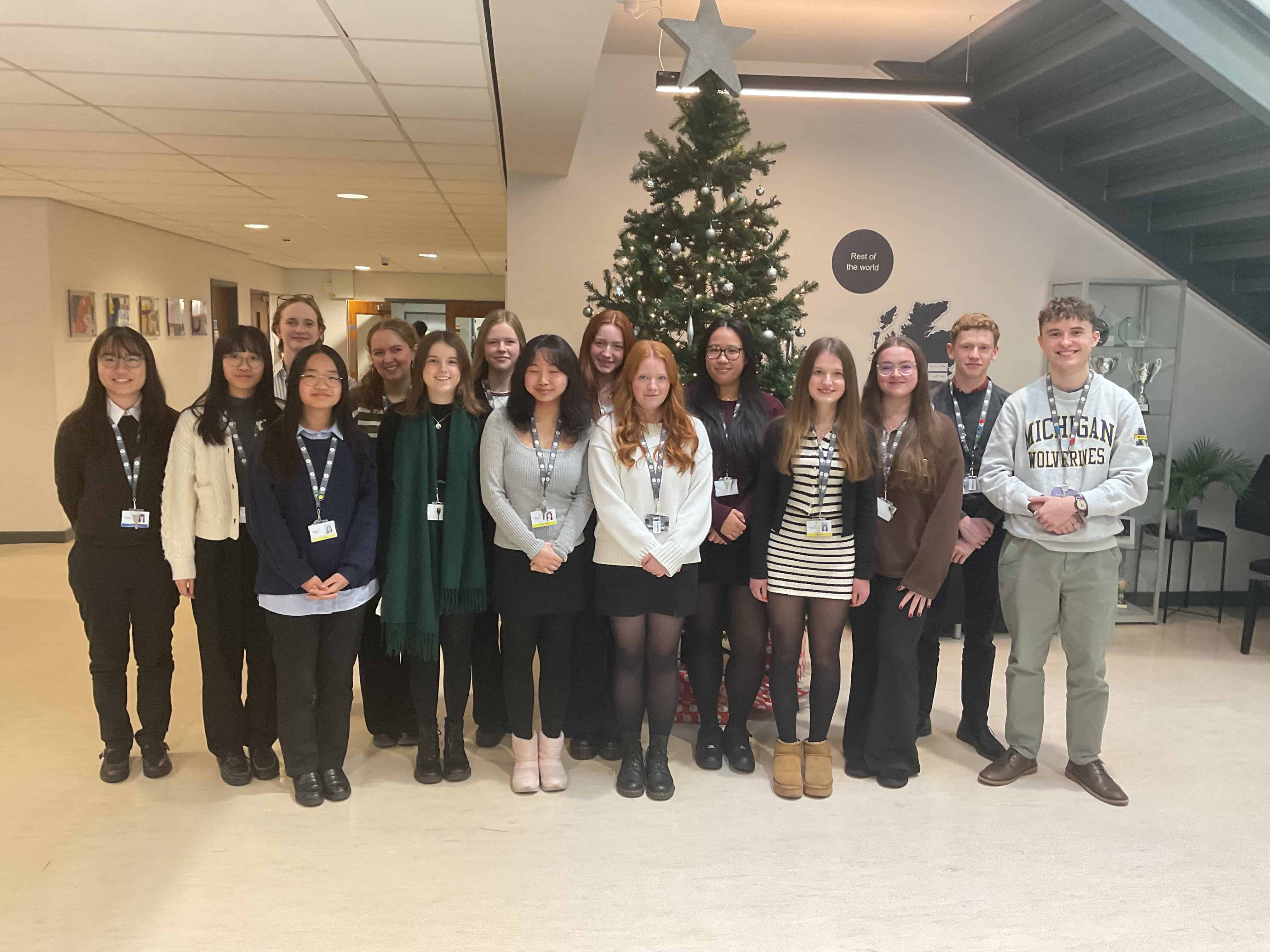 Students stood infront of Christmas tree